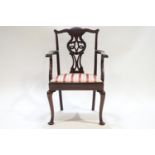 A child's mahogany Chippendale style carver with pierced and carved splat over a drop in seat