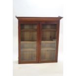 A mahogany glazed two door bookcase with plinth top,