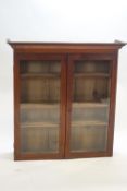 A mahogany glazed two door bookcase with plinth top,