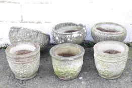 Two composition stone garden urns with gadrooned decoration,