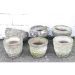 Two composition stone garden urns with gadrooned decoration,