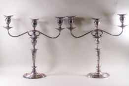 A pair of early 19th century Sheffield plate candlestick/three branch candelabra combinations on