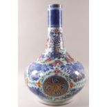 A 19th century Chinese baluster vase decorated in the Cantonese famille rose palette over blue