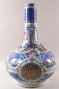 A 19th century Chinese baluster vase decorated in the Cantonese famille rose palette over blue