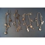 A collection of four bracelets all fixed with assorted charms. Marked for sterling silver 925.