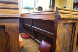 A Victorian pine pew with double paneled back and prayer book shelf to the reverse 83cm high,