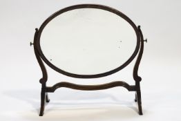 An Edwardian mahogany oval swing frame mirror,