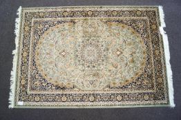 A beige ground Keshan carpet,