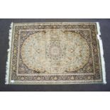 A beige ground Keshan carpet,