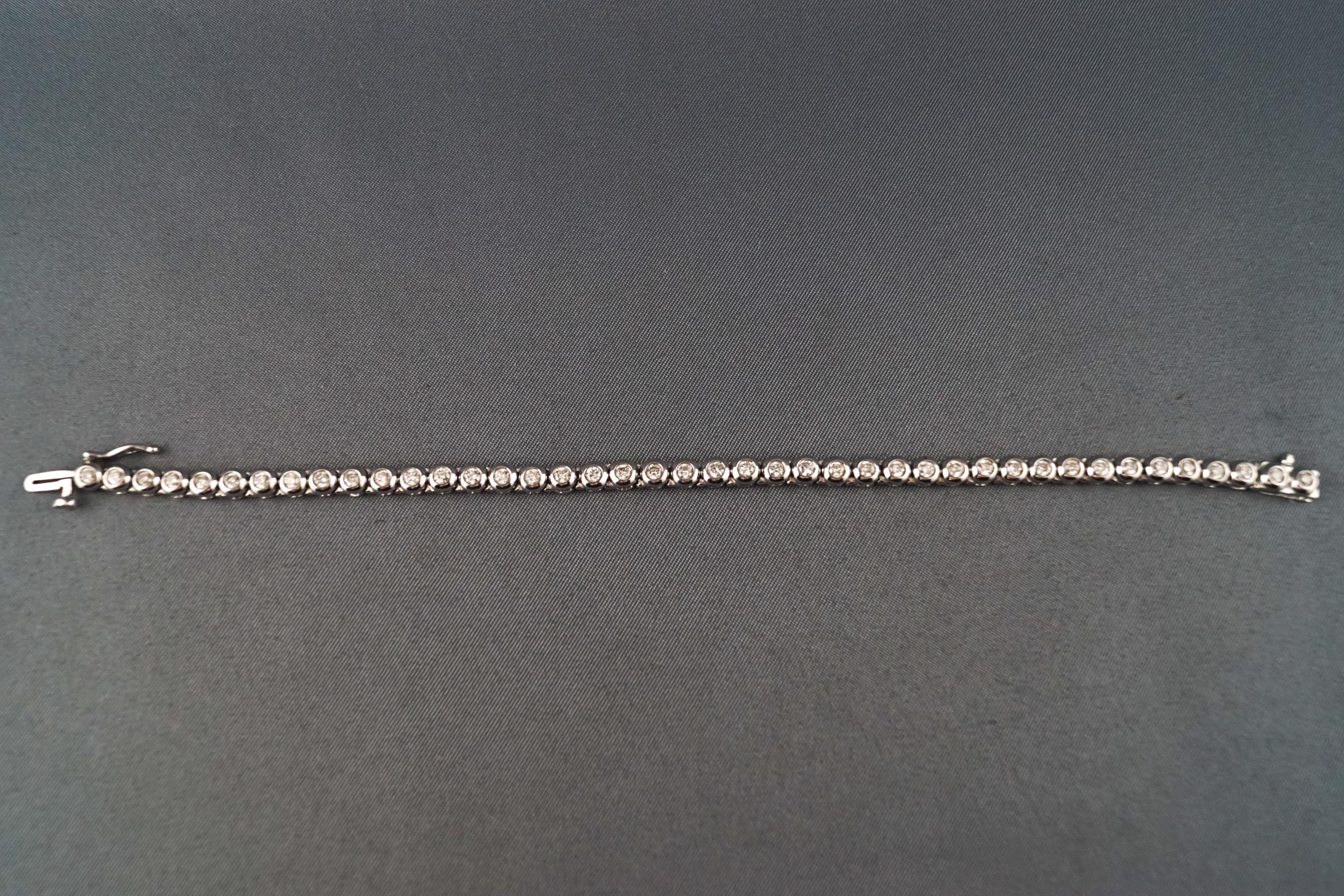 A modern white metal diamond line bracelet.