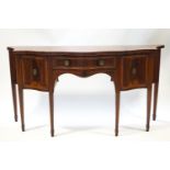 A George III mahogany sideboard with serpentine front and satinwood cross banding