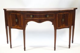 A George III mahogany sideboard with serpentine front and satinwood cross banding