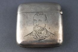 A silver vesta case of square form, engraved with a portrait of a gentleman in Victorian clothes,