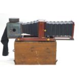 A mahogany and brass plate field camera, of massive proportions,