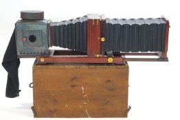 A mahogany and brass plate field camera, of massive proportions,