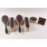 A four piece pique decorated tortoiseshell and silver dressing table set, London 1924,