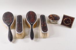 A four piece pique decorated tortoiseshell and silver dressing table set, London 1924,