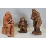 Ron Olley - A terracotta figure of a seated beggar, 28cm high and two ceramic en suite,