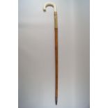 A malacca walking stick with brass mount and simulated ivory handle,