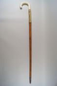 A malacca walking stick with brass mount and simulated ivory handle,