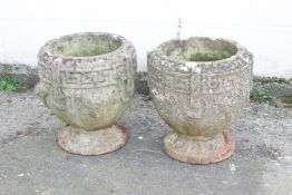 A pair of composite stone garden urns with Greek key fret borders, 38cm high,