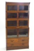 A mahogany sectional bookcase on a plain base with one long and two short drawers