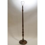 A turned beech wood standard lamp, decorated with lacquered detail in the Japanese style,