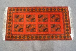 A terracotta ground Asian carpet,