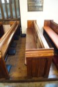 A Victorian pine pew with triple paneled back and prayer book shelf to reverse with one wall end