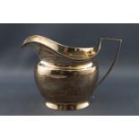 A silver milk jug of plain bevelled form on splayed foot, London 1806, 9cm high,