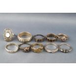 A collection of ten silver rings of variable designs to include stone set and plain.