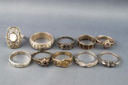 A collection of ten silver rings of variable designs to include stone set and plain.