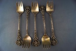 Five gilt cake forks, with double struck open contrived foliate handles,