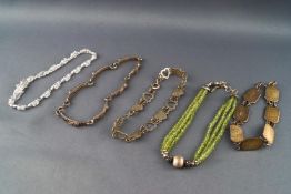 A collection of five silver bracelets to include beaded, gem set and Celtic designs.