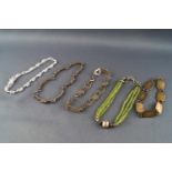 A collection of five silver bracelets to include beaded, gem set and Celtic designs.
