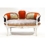 A small painted carved wood sofa with curved ends,