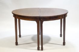 A George III mahogany double 'D' end dining table with central loose leaf