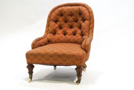 A Victorian nursing chair with button back and turned and fluted legs