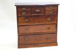 A mixed hardwood Scottish style chest of drawers with a central deep drawer