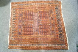 A rug with repeating geometric motifs within multiple borders on a red ground,