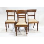 Four Regency mahogany dining chairs of plain form with splat backs and tip in seats