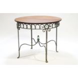 A metal base table of Empire form with round mahogany top,