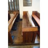 A Victorian pine pew with triple paneled back and prayer book shelf to reverse with one wall end