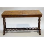 A walnut carved and veneered writing table,