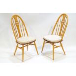 A pair of Ercol bent beech wood and elm Windsor style dining chairs,