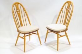 A pair of Ercol bent beech wood and elm Windsor style dining chairs,