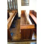 A Victorian pine pew with triple paneled back and prayer book shelf to reverse with one wall end