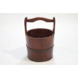 A staved and coopered log bucket,