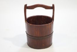 A staved and coopered log bucket,