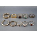 A collection of ten silver rings of variable designs with gem set and plain. One is 925 gold plated.